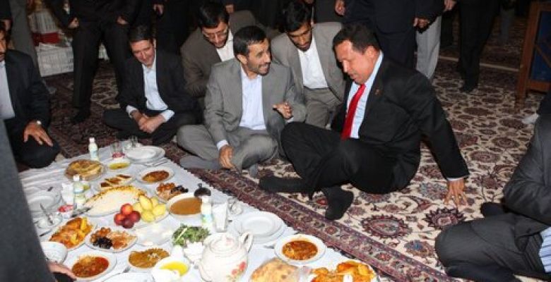 Ahmadinejad's attempt to make Hugo Chavez eat food while sitting cross-legged on the floor