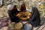 Palestinian women bake traditional cookies filled with dates