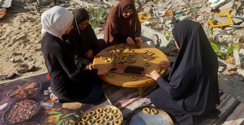 Palestinian women bake traditional cookies filled with dates
