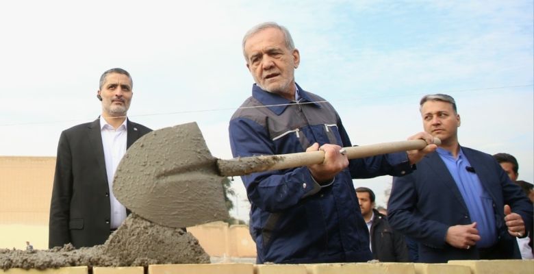 President is working on building a school while wearing work clothes